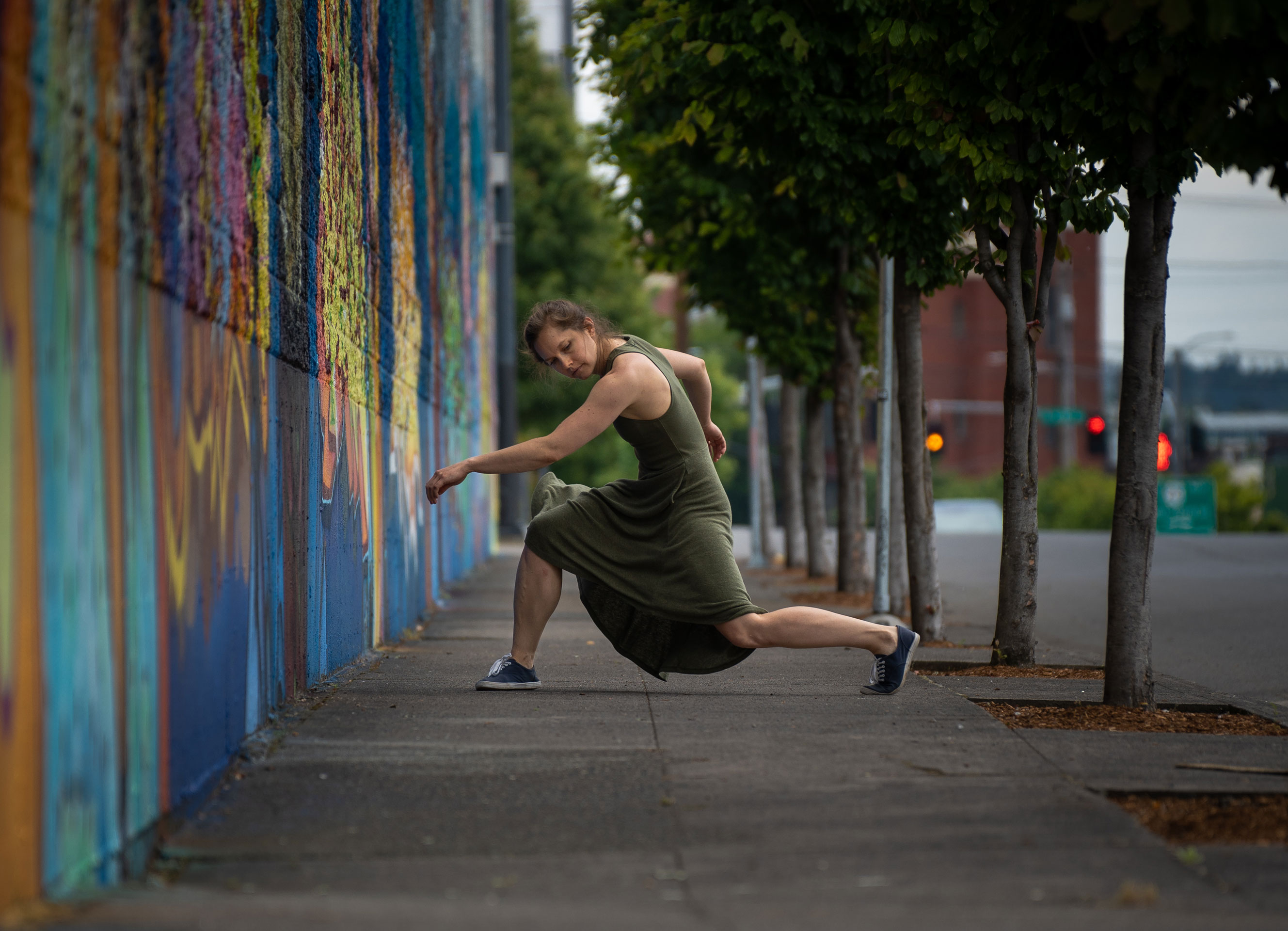 push/FOLD's managing director Holly Shaw dancing next to a large wall featuring graffiti in Portland, OR | Photography: Samuel Hobbs